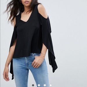 Black top with cold shoulders and dramatic flair